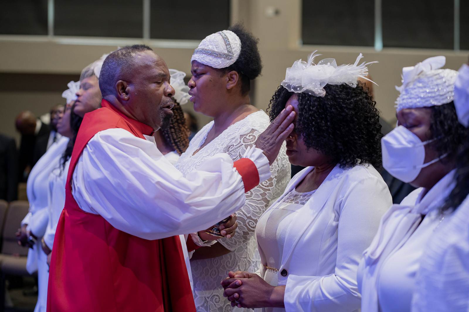 An apostolic group standing in a church wearing white robes.