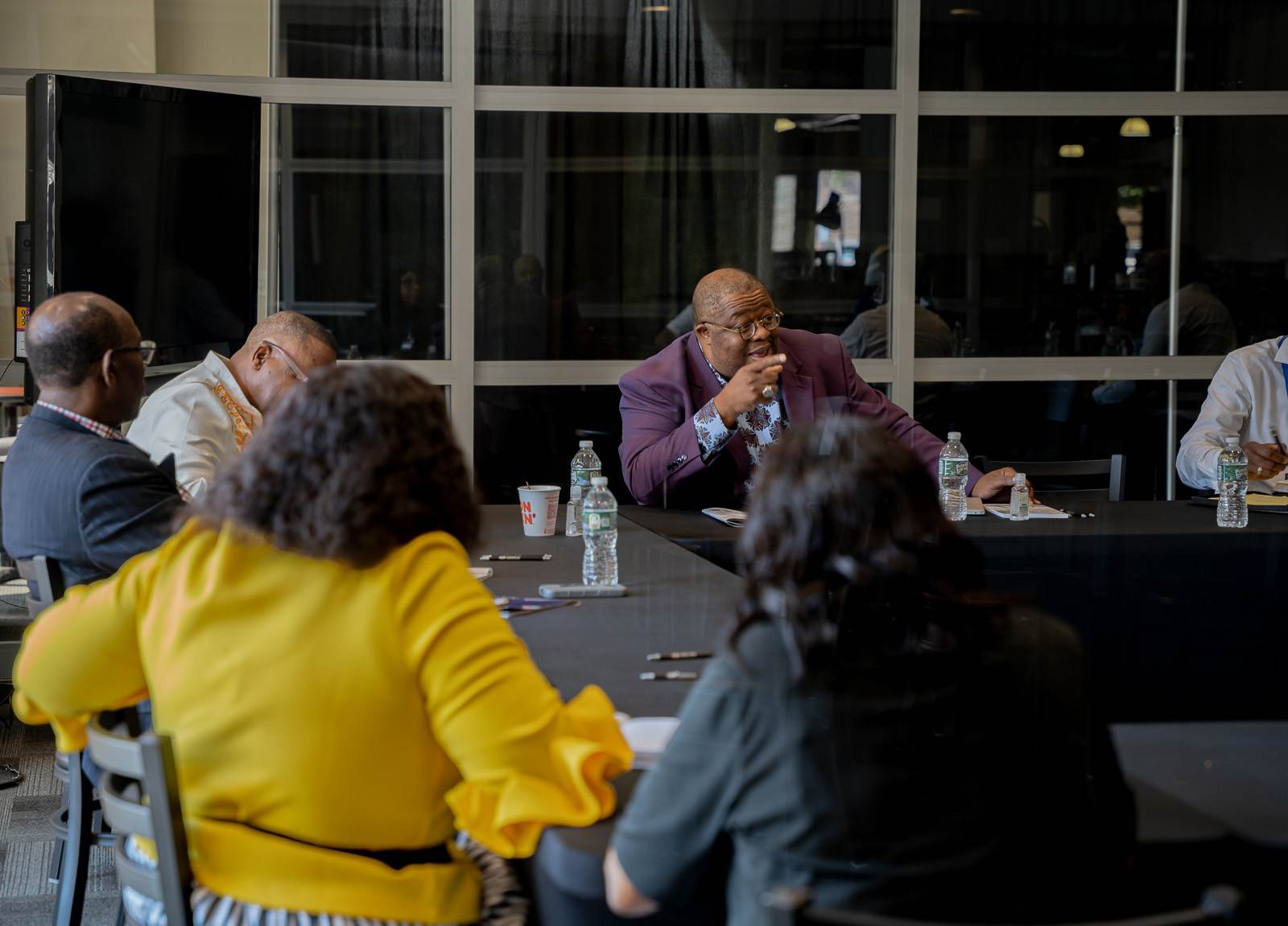 Apostolic church congregation gathered around a table.