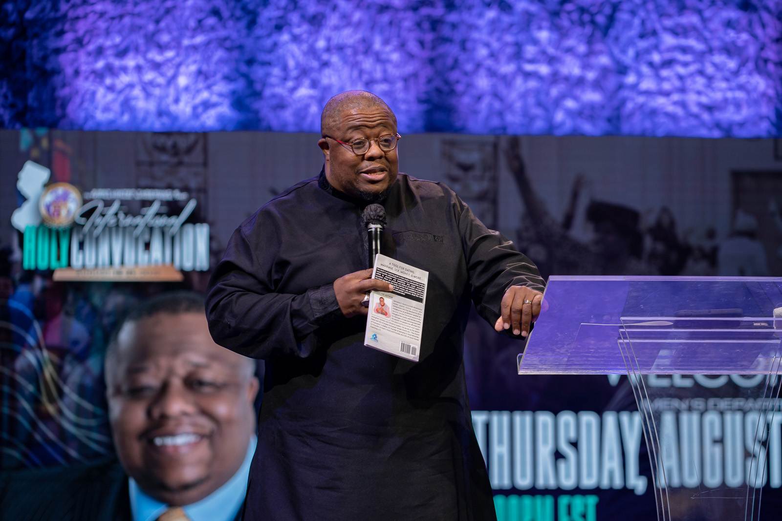 A man speaking at a podium in front of a church stage.