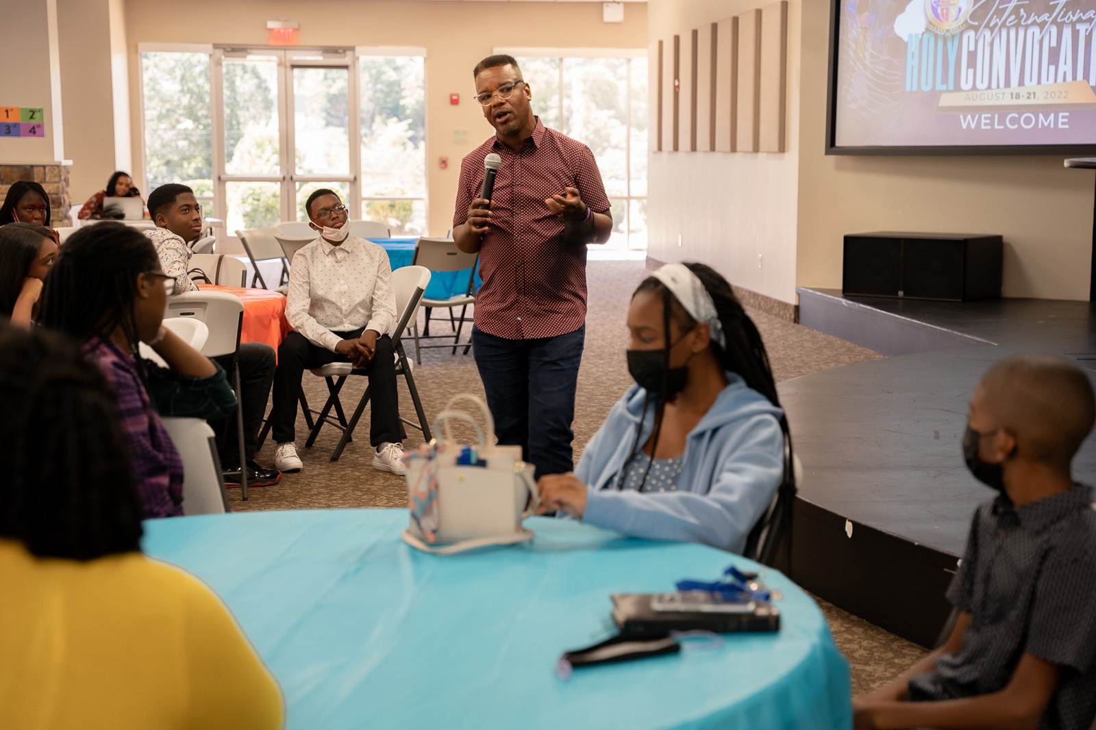 A man giving a presentation to an apostolic church group.